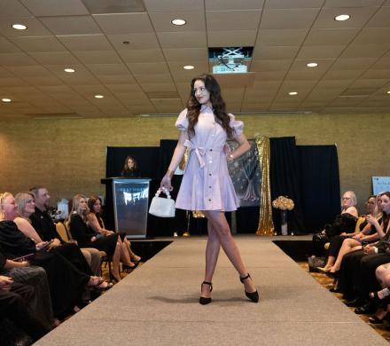 A model poses on the during the Little Black Dress Event Fashion Show