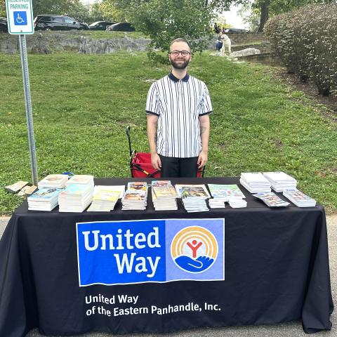 A United Way Employee sets up a book distribution stand at a Berkeley County event.